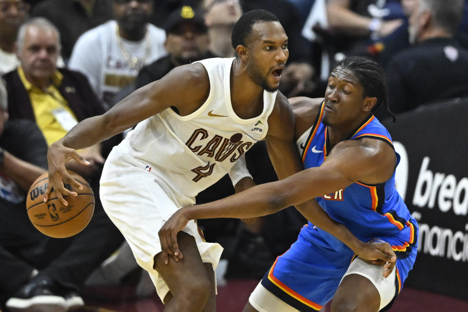 Oct 27, 2023; Cleveland, Ohio, USA; Oklahoma City Thunder forward Jalen Williams (8) hits the ball from Cleveland Cavaliers forward Evan Mobley (4) in the second quarter at Rocket Mortgage FieldHouse. Mandatory Credit: David Richard-USA TODAY Sports
