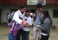 Free Peru party presidential candidate Pedro Castillo embraces his family before leaving his home to prepare for his electoral campaign, in Chugur, Peru, Friday, April 16, 2021. Castillo, a rural teacher, who has proposed rewriting Peru's constitution and deporting all immigrants living in the country illegally who commit crimes, will face rival candidate Keiko Fujimori in the June 6 presidential run-off election. (AP Photo/Martin Mejia)