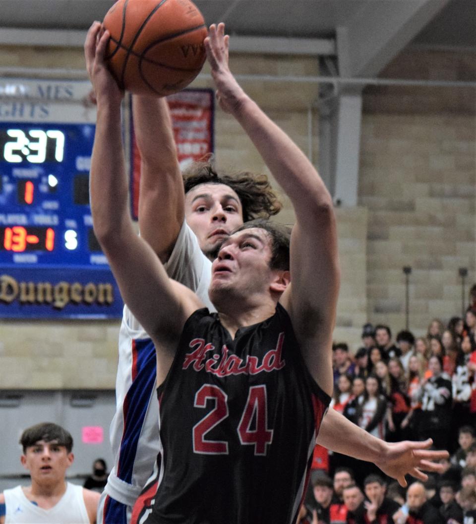 Zander Shultz blocks from behind this shot attempt by Hiland's Chris Shetler