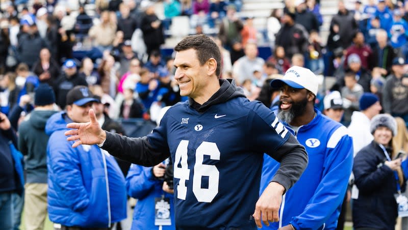 BYU alumnus and current special teams coach Kelly Poppinga walks on the field during at LaVell Edwards Stadium  in Provo on March 31, 2023.