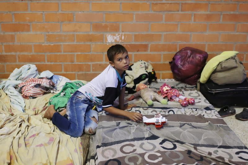 A Venezuelan migrant child plays inside a coliseum where a temporary camp has been set up, after fleeing his country due to military operations, according to the Colombian migration agency, in Arauquita