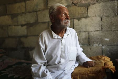 Ibrahim Mohammad al-Toum, 85, poses in his home that he says has been bombed three times in six years by the Israeli army, in Gaza City, August 11, 2014. REUTERS/Siegfried Modola