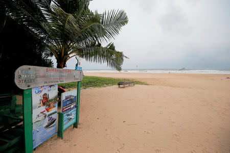 An empty beach is seen near a sign of the boat safari and whale watching center in a tourist area in Bentota, Sri Lanka May 2, 2019. REUTERS/Dinuka Liyanawatte