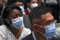 Journalists wearing a protective face mask to help curb the spread of the new coronavirus attend a press conference for the white paper on fighting COVID-19 China in action which is chaired by Xu Lin, vice head of the publicity department of the communist party, at the State Council Information Office in Beijing, Sunday, June 7, 2020. Senior Chinese health officials defended their country's response to the new coronavirus pandemic, saying they provided information in a timely and transparent manner. (AP Photo/Andy Wong)