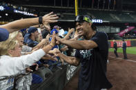 Seattle Mariners' Julio Rodriguez celebrates with fans after the team's baseball game against the Oakland Athletics, Friday, Sept. 30, 2022, in Seattle. The Mariners won 2-1 to clinch a spot in the playoffs. (AP Photo/Stephen Brashear)