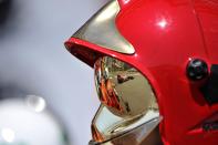 Red Bull Racing's German driver Sebastian Vettel is reflected in a fireman's helmet as he drives during the qualifying session at the Circuit de Monaco on May 26, 2012 in Monte Carlo ahead of the Monaco Formula One Grand Prix. AFP PHOTO / BORIS HORVATBORIS HORVAT/AFP/GettyImages