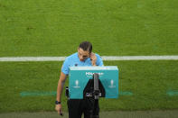 The referee checks the VAR for possible penalty for Georgia during a Group F match between Georgia and Portugal at the Euro 2024 soccer tournament in Gelsenkirchen, Germany, Wednesday, June 26, 2024. (AP Photo/Andreea Alexandru)