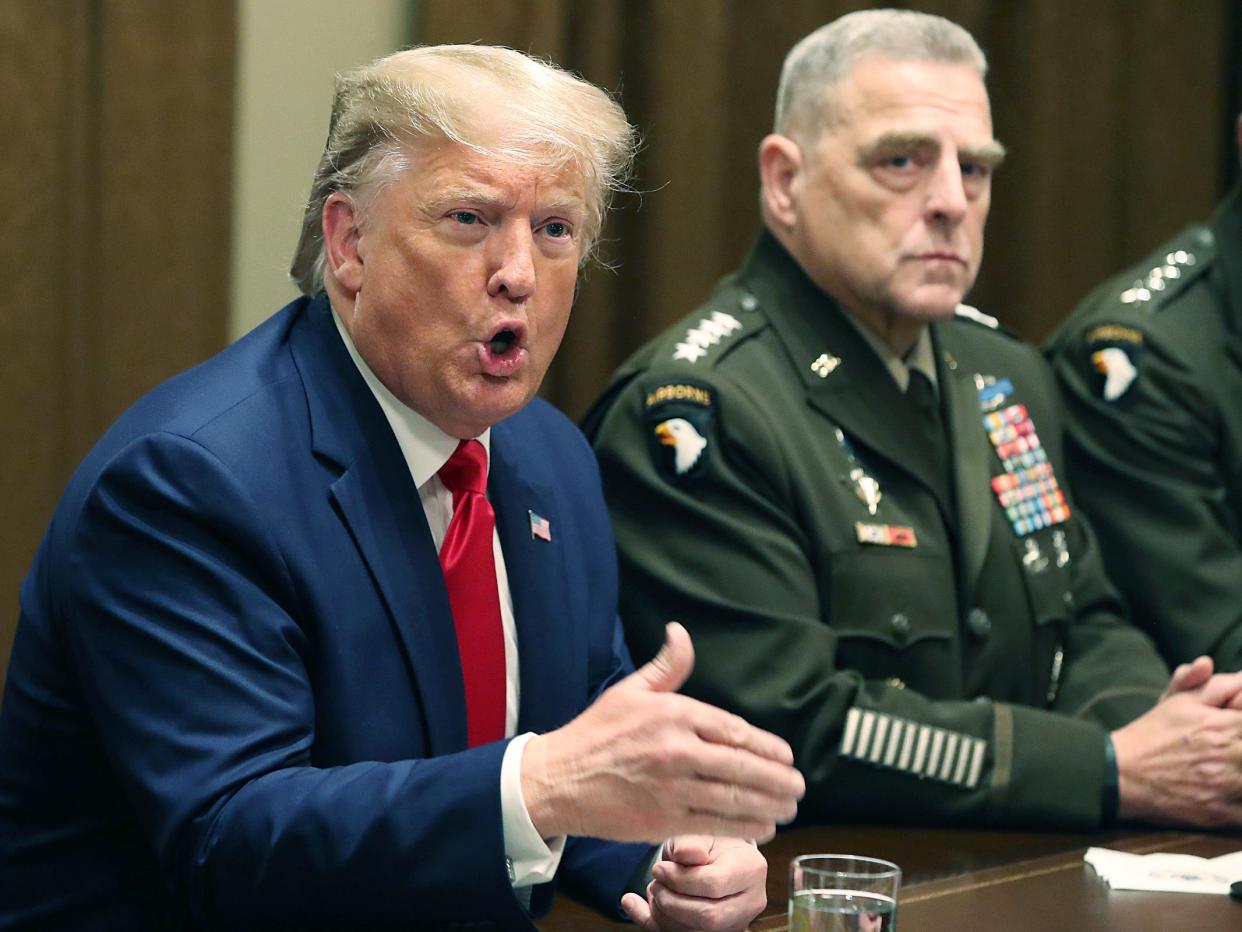 U.S. President Donald Trump speaks as Joint Chiefs of Staff Chairman, Army General Mark Milley looks on after a briefing from senior military leaders in the Cabinet Room at the White House on October 7, 2019 in Washington, DC. (Getty Images)