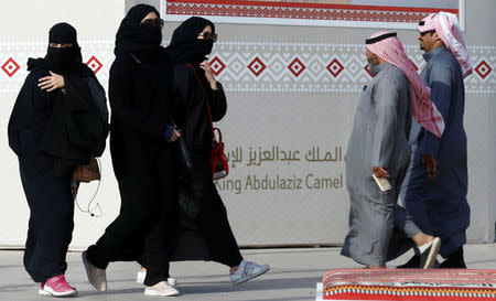 People walk during King Abdulaziz Camel Festival in Rimah Governorate, north-east of Riyadh, Saudi Arabia January 19, 2018. REUTERS/Faisal Al Nasser