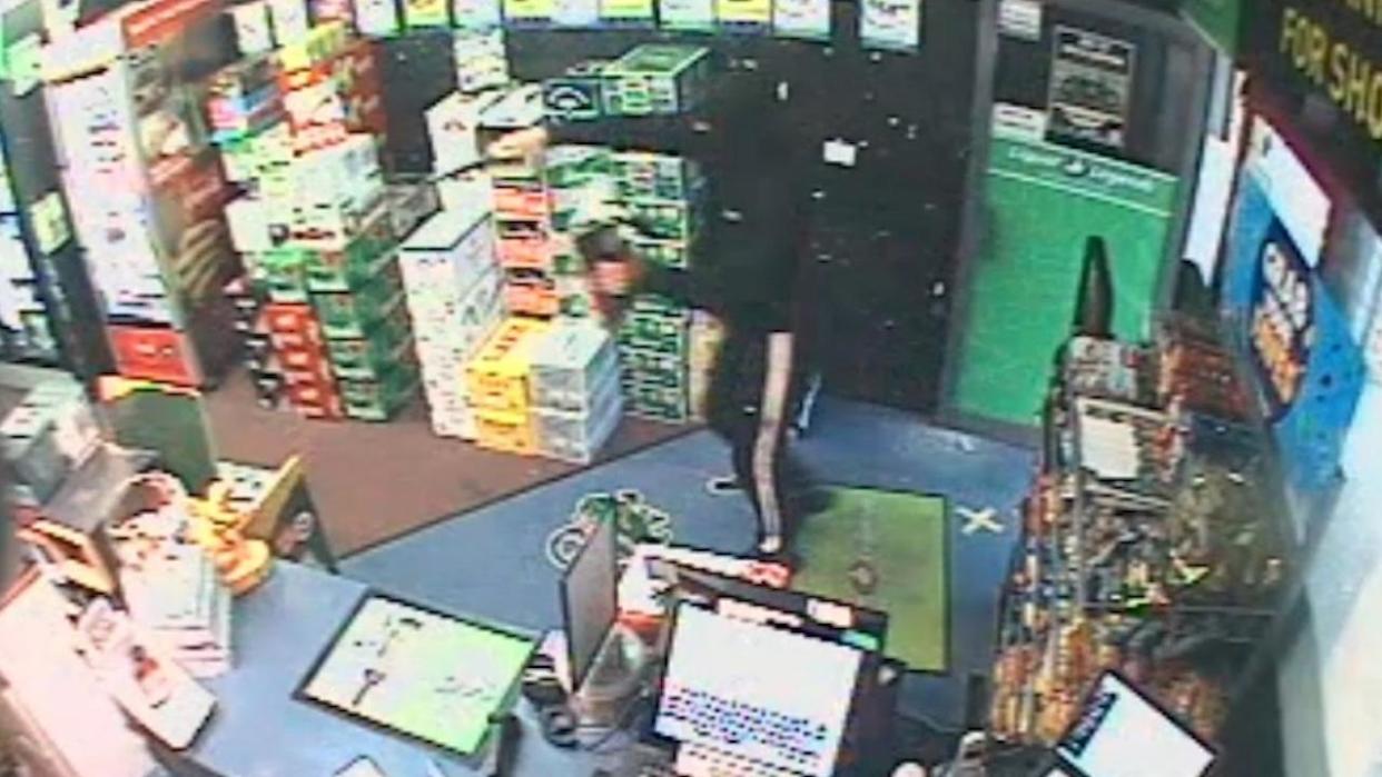 CCTV captured the man brandishing a large knife at a Robina bottle shop worker. Picture: Supplied / QPS