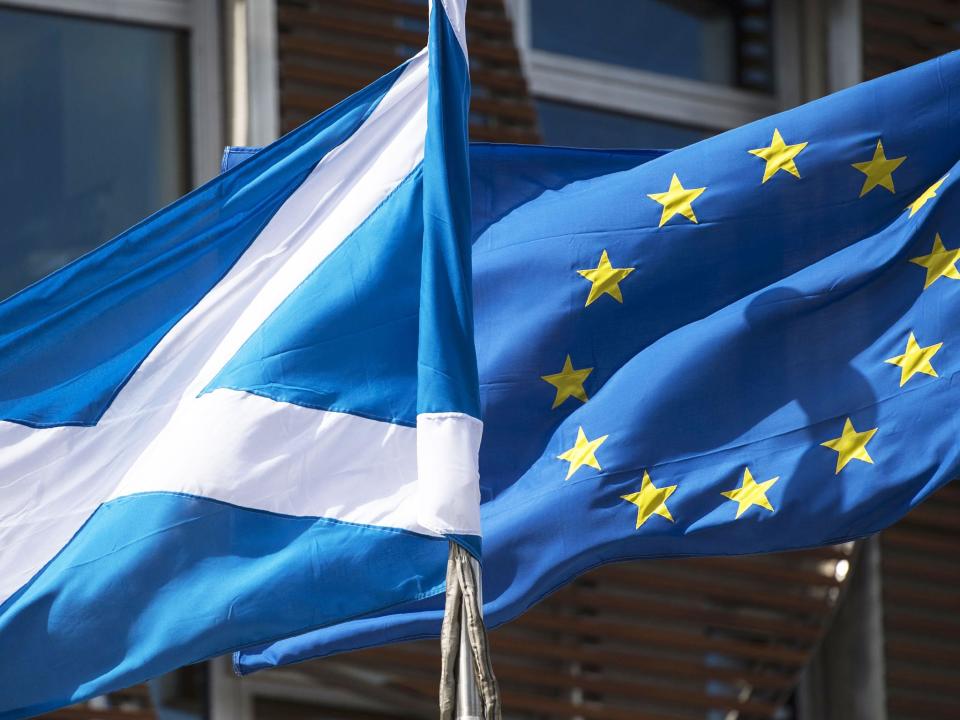 A Scottish Saltire and a European Union flag fly in front of the Scottish Parliament building in Edinburgh: Getty