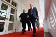 <p>North Korea’s leader Kim Jong Un (L) walks with US President Donald Trump (R) at the start of their historic US-North Korea summit, at the Capella Hotel on Sentosa island in Singapore on June 12, 2018. (Photo: Saul Loeb/AFP/Getty Images) </p>