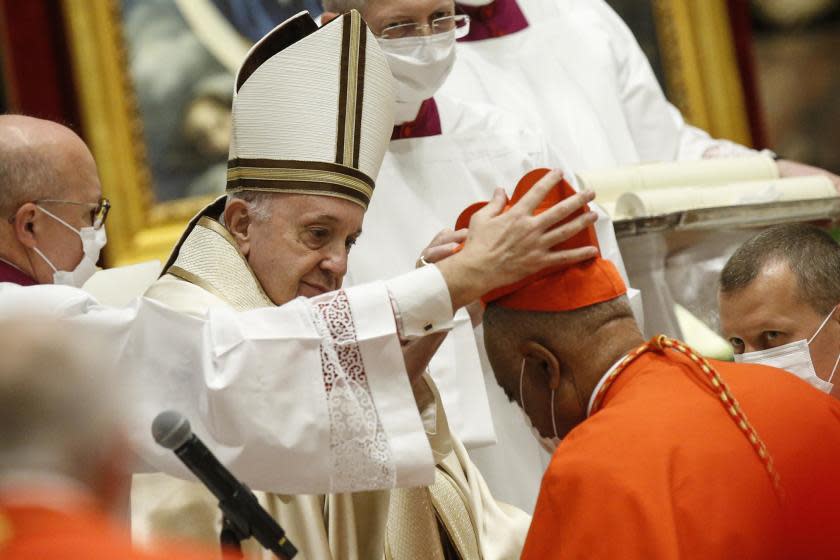 American newly Cardinal Wilton D. Gregory receives his biretta as he is appointed cardinal by Pope Francis, during a consistory ceremony where 13 bishops were elevated to a cardinal's rank in St. Peter's Basilica at the Vatican, Saturday, Nov. 28, 2020. (Fabio Frustaci/POOL via AP)