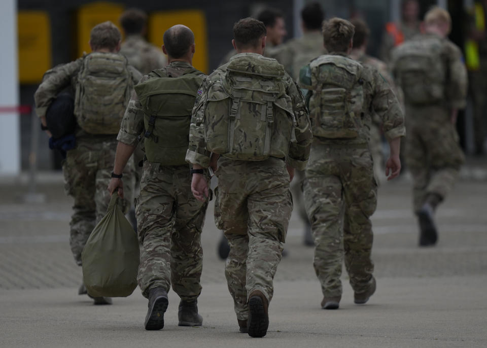 Members of the British armed forces 16 Air Assault Brigade walk to the air terminal after disembarking a Royal Airforce Voyager aircraft at Brize Norton, England, as they return from helping in operations to evacuate people from Kabul airport in Afghanistan, Saturday, Aug. 28, 2021. More than 100,000 people have been safely evacuated through the Kabul airport, according to the U.S., but thousands more are struggling to leave in one of history's biggest airlifts. (AP Photo/Alastair Grant, Pool)
