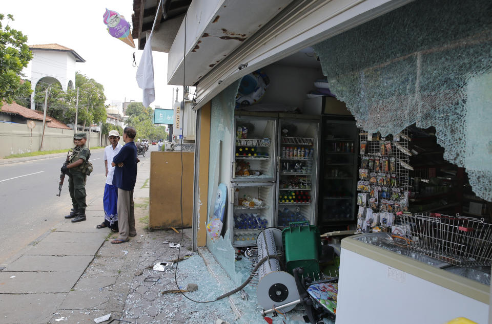 Sri Lankan army soldiers secure the area around vandalized properties owned by Muslims following an overnight clash with Christians in Poruthota, a village in Negombo, about 35 kilometers North of Colombo, Sri Lanka, Monday, May 6, 2019. Two people have been arrested and an overnight curfew lifted Monday after mobs attacked Muslim-owned shops and some vehicles in a Sri Lankan town where a suicide bombing targeted a Catholic church last month. Residents in the seaside town of Negombo say the mostly-Catholic attackers stoned and vandalized shops. It is unclear how the dispute began but most residents say a private dispute took a religious turn. (AP Photo/Eranga Jayawardena)