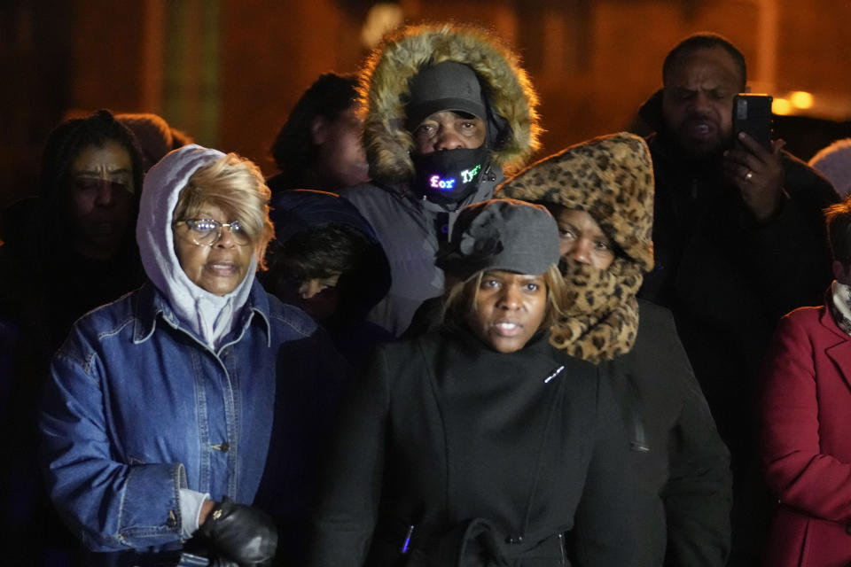 Rodney Wells, center, stepfather of Tyre Nichols, listens to speakers at a prayer gathering at the site where Nichols was beaten by Memphis police officers, and later died from his injuries, in Memphis, Tenn., Monday, Jan. 30, 2023. (AP Photo/Gerald Herbert)