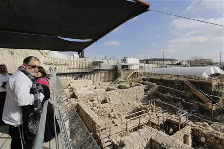 A visitor looks at the archaeological site known as the City of David, situated just outside the Old City in East Jerusalem January 23, 2014. REUTERS/Ammar Awad