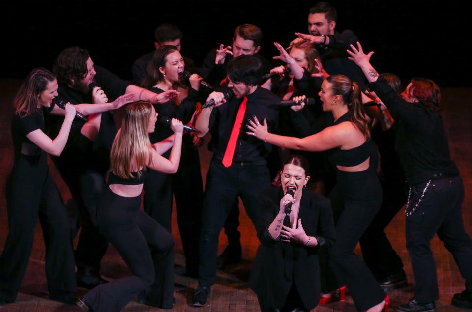 The University of Delaware's MelUDees, including Cole Walker (in tie) and Sydney Levine (front), performs during the International Championship of Collegiate A Cappella Mid-Atlantic semifinal competition at the Playhouse on Rodney Square in Wilmington on Saturday, March 25, 2023.