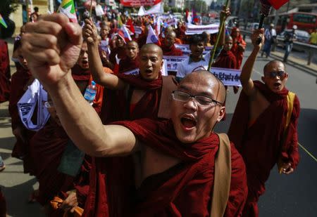 Buddhist monks and other people take part in a protest to demand the revocation of the right of holders of temporary identification cards, known as white cards, to vote, in Yangon February 11, 2015. REUTERS/Soe Zeya Tun