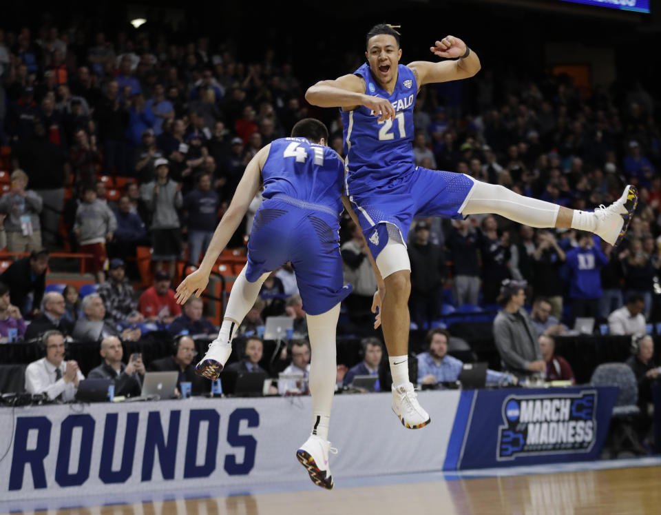 Buffalo’s Dominic Johnson, right, and Brock Bertram celebrate after Buffalo upset Arizona 89-68 in first-round game in the NCAA men’s college basketball tournament. (AP)