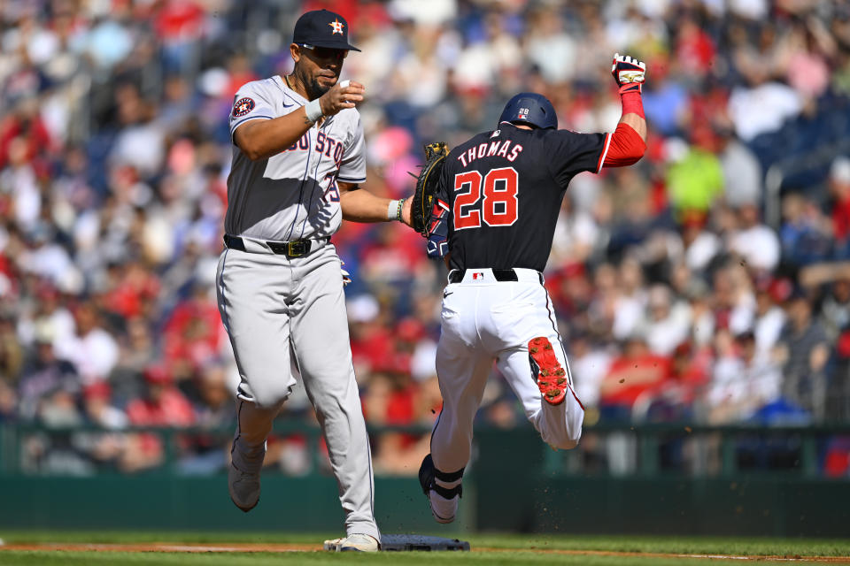 Houston Astros first base José Abreu, left, tags Washington Nationals Thomas for the second out at first base during the first inning of a baseball game at Nationals Park, Saturday, April 20, 2024, in Washington. (AP Photo/John McDonnell)