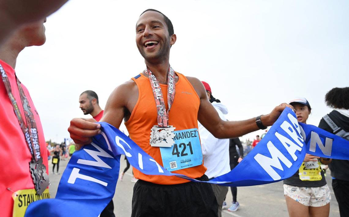 Patrick Fernandez from Avalon celebrates his first-place finish in the full 26.2-mile marathon at the annual Two Cities Marathon, which started and finished at the Clovis Community College campus Sunday, Nov. 6, 2022, in Fresno. Fernandez’ time of 2 hours, 22 minutes, 48 seconds was almost 15 minutes faster than the second-place finisher.