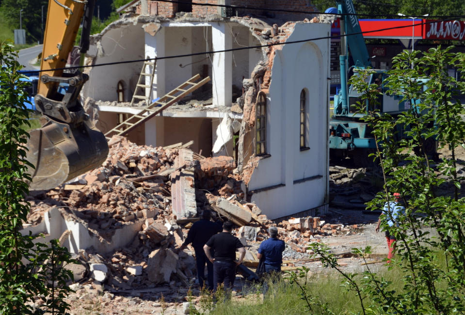 An orthodox church is demolished in Konjevic Polje, the village next to Srebrenica in Bosnia, Saturday, June 5, 2021. Bosnian authorities have demolished a Serbian Orthodox church illegally built on the land owned by a Bosniak woman after a 20-year-long legal battle that reached the European Court of Human Rights. Workers and construction machinery arrived at Fata Orlovic’s yard in the village of Konjevic Polje early Saturday. (AP Photo/Sladjan Vasic)