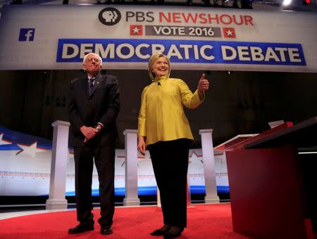 Democratic U.S. presidential candidates Senator Bernie Sanders and former Secretary of State Hillary Clinton arrive on stage ahead of the start of the PBS NewsHour Democratic presidential candidates debate in Milwaukee, Wisconsin, February 11, 2016. REUTERS/Darren Hauck