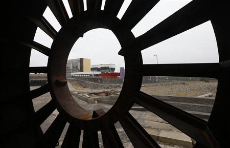 Heysham nuclear power station is seen through a piece of scrap metal at Heysham Harbour in northwest England April 22, 2013. REUTERS/Suzanne Plunkett