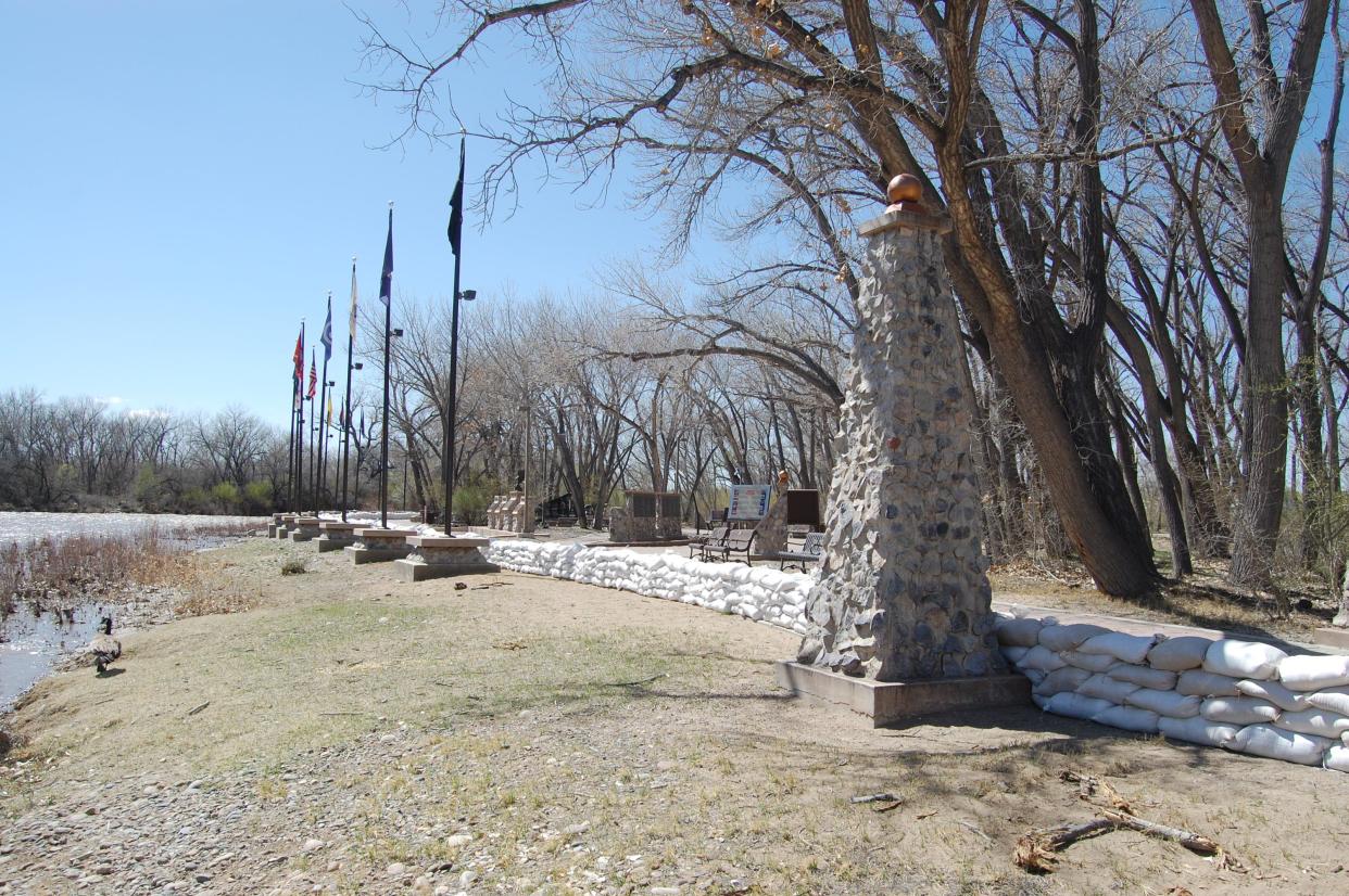 A barrier of sandbags protects All Veterans Memorial Plaza from the rising waters of the Animas River near Berg Park on Monday, April 17.