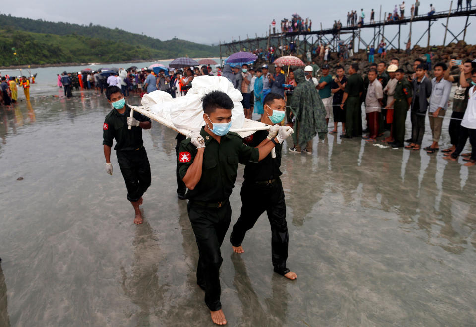 Soldiers carry bodies ashore