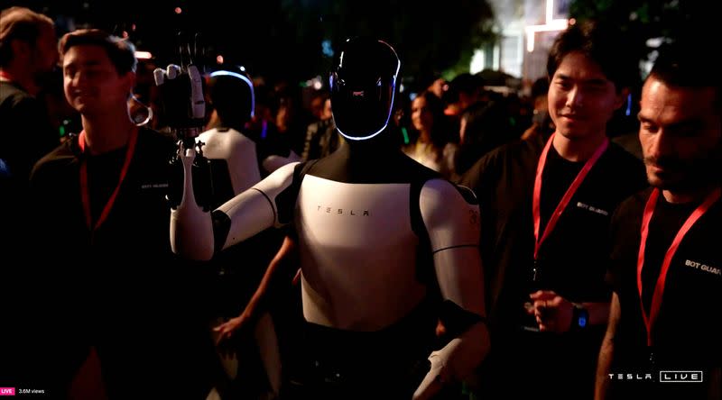 Tesla's Optimus robot gestures on the day of an unveiling event in Los Angeles