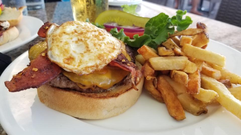 The Pier 22 Burger in Bradenton with avocado, basil mayo, fried egg, smoked Cheddar and brown sugar spiced bacon.