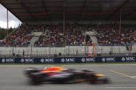 Fans watch from the stands as Red Bull driver Max Verstappen of the Netherlands passes by during the Formula One Grand Prix at the Spa-Francorchamps racetrack in Spa, Belgium, Sunday, July 30, 2023. (Simon Wohlfahrt, Pool Photo via AP)