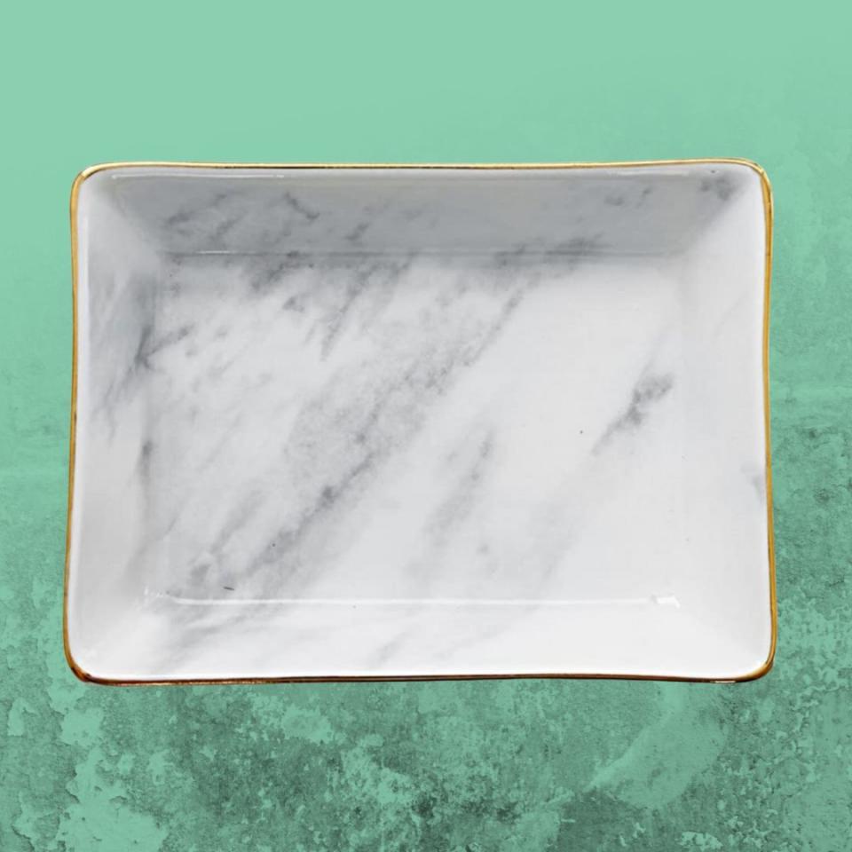 Love the look of marble but don't want to spring for it? This stylish tray adds a bit of sophisticated glimmer to your bedside table while also keeping your space tidy.You can buy the ceramic catchall with a marble finish from Amazon for around $9-$11. 