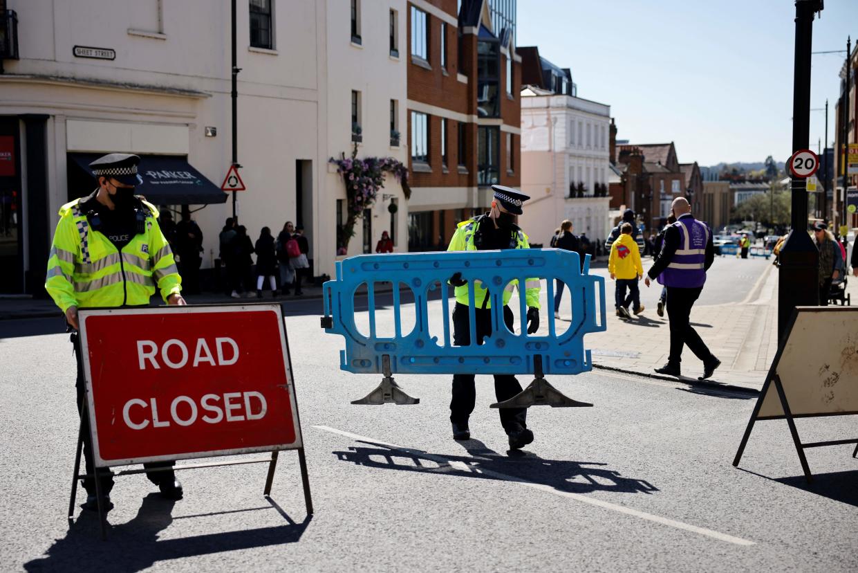 Police officers close the road leading to Windsor Castle in Windsor, west of London, on April 17, 2021 ahead of the funeral of Britain's Prince Philip, Duke of Edinburgh. - Philip, who was married to Queen Elizabeth II for 73 years, died on April 9 aged 99 just weeks after a month-long stay in hospital for treatment to a heart condition and an infection. (Photo by Tolga Akmen / AFP) (Photo by TOLGA AKMEN/AFP via Getty Images)