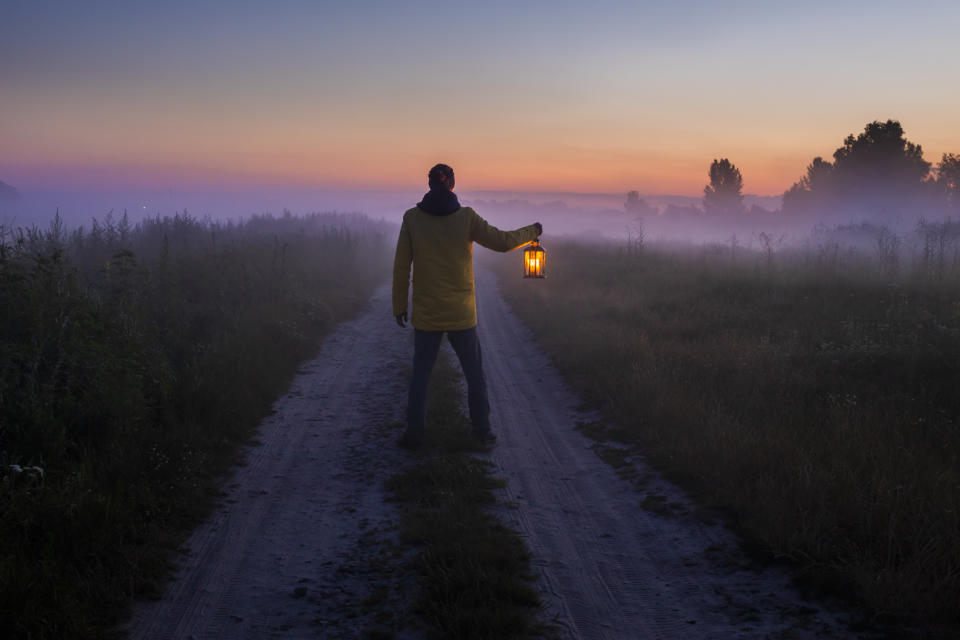 The explorer is looking for the right path at dusk