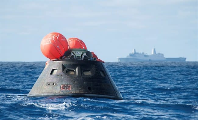 NASA's Orion spacecraft awaits the U.S. Navy's USS Anchorage in the Pacific Ocean. (AP Canada)