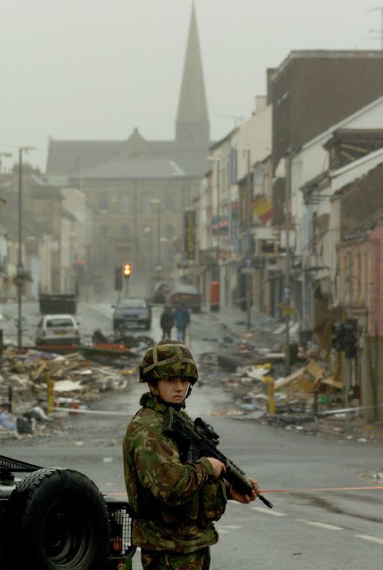 FILE PHOTO: A soldier guards the scene of the bombing in Omagh's shopping area in Northern Ireland