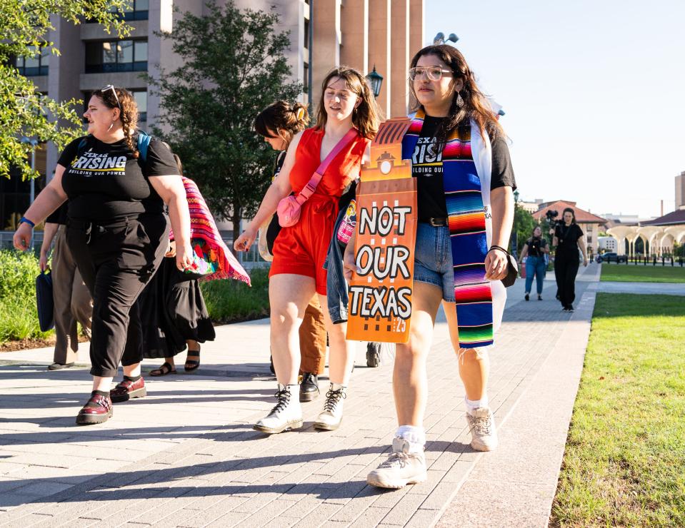 University of Texas graduate Jackie Compos, right, marches with others from the UT campus to the Capitol ahead of a Texas Senate Higher Education Subcommittee hearing Tuesday on campus free speech and Senate Bill 17, the bill banning diversity initiatives in Texas public colleges.