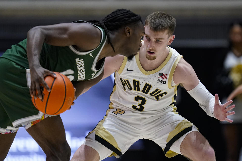 Purdue guard Braden Smith (3) defends Jacksonville guard Robert McCray V (13) during the second half of an NCAA college basketball game in West Lafayette, Ind., Thursday, Dec. 21, 2023. (AP Photo/Michael Conroy)