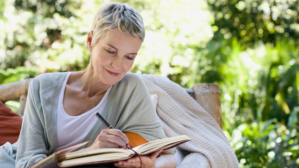 woman writing in journal to end irritability in menopause