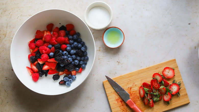 Cutting summer berries on board