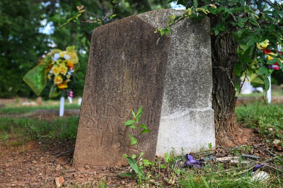 Headstones dating back to the early 1900s, and even the 1800s, stand askew in the graveyard of Moore’s Sanctuary AME Zion Church on Tuesday, April 16, 2023. An effort us underway to revitalize the graveyard and help preserve part of Charlotte’s Black history.