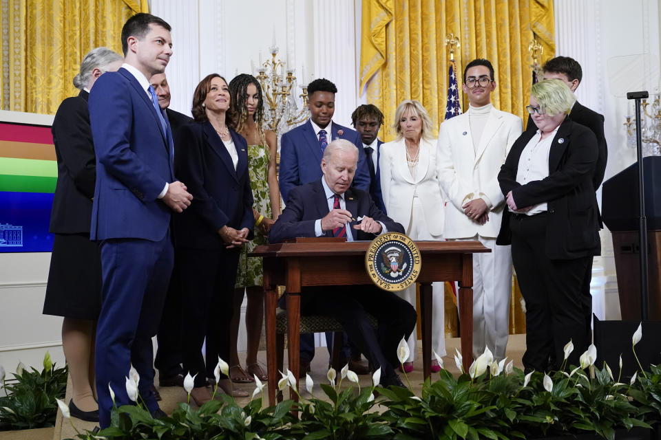 FILE - President Joe Biden signs an executive order at an event to celebrate Pride Month in the East Room of the White House, June 15, 2022, in Washington. Biden plans to sign legislation this coming week that will protect gay unions even if the Supreme Court revisits its ruling supporting a nationwide right of same-sex couples to marry. It's the latest part of Biden's legacy on gay rights, which includes his unexpected endorsement of marriage equality on national television a decade ago when he was vice president. (AP Photo/Patrick Semansky, File)