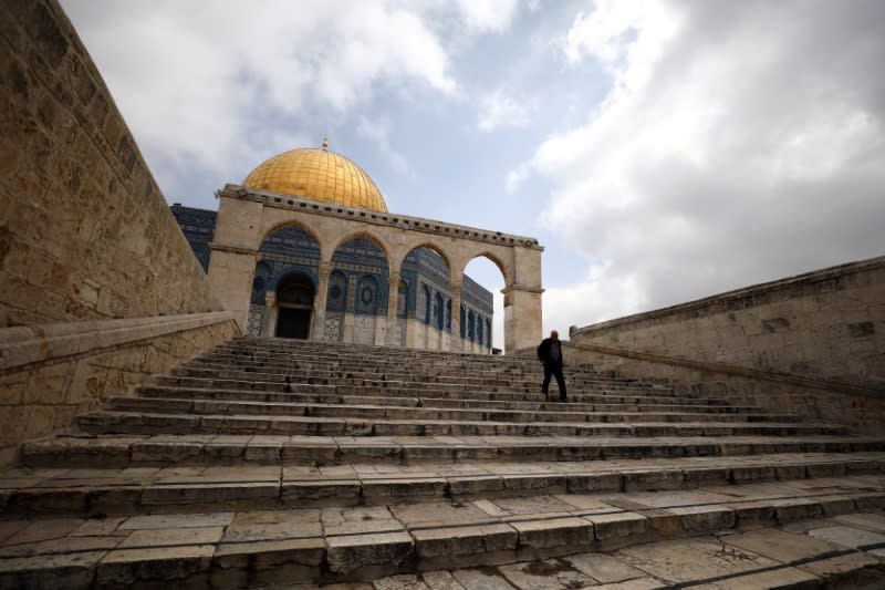 FILE PHOTO: A man walks in front of the Dome of the Rock in Jerusalem's Old City