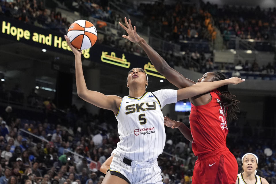 Chicago Sky's Angel Reese (5) shoots past the out stretch arm of Atlanta Dream's Tina Charles during the second half of a WNBA basketball game Wednesday, July 10, 2024, in Chicago. The Sky won 78-69. (AP Photo/Charles Rex Arbogast)