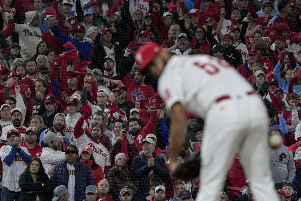 Fans cheer as Philadelphia Phillies relief pitcher Seranthony Dominguez pitches during the eighth inning in Game 3 of the baseball NL Championship Series between the San Diego Padres and the Philadelphia Phillies on Friday, Oct. 21, 2022, in Philadelphia. (AP Photo/Matt Slocum)
