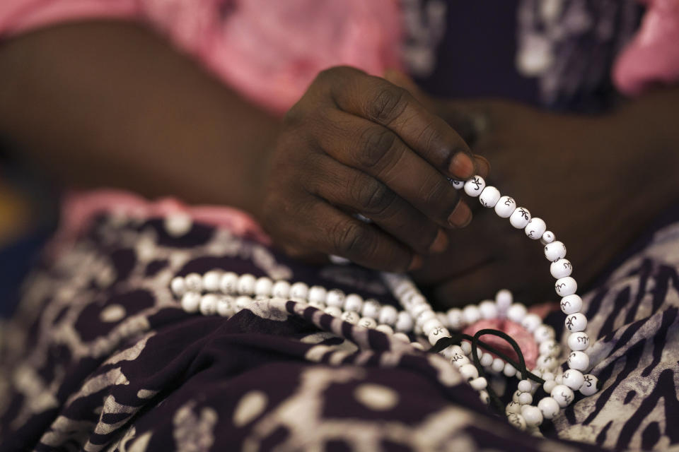 Seynabou Diop holds her prayer beads as she talks about her son, Khadim Ba, 21, who died during the protests earlier this month in Dakar, Senegal, Thursday, June 15, 2023. "If I had known (he was going to protest), Khadim would never have taken part," said Diop. "I want (the government) to meet the expectations of young people, the government has an obligation to help (them)," she said. (AP Photo/Leo Correa)