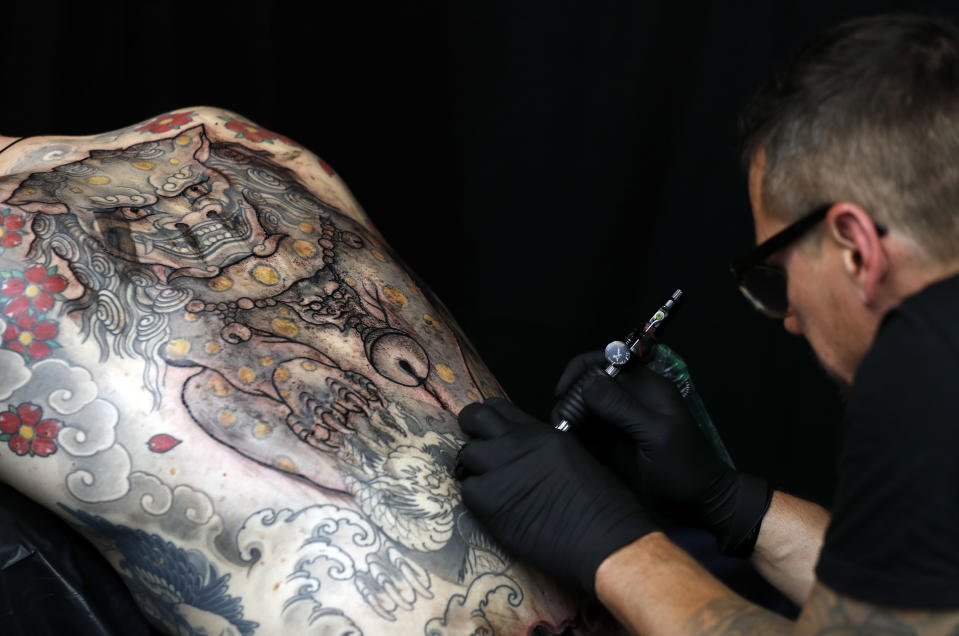 <p>A man is tattooed by Thomas Schehr of Germany at The International Tattoo Convention in London, Friday, Sept. 22, 2017. (Photo: Kirsty Wigglesworth/AP) </p>